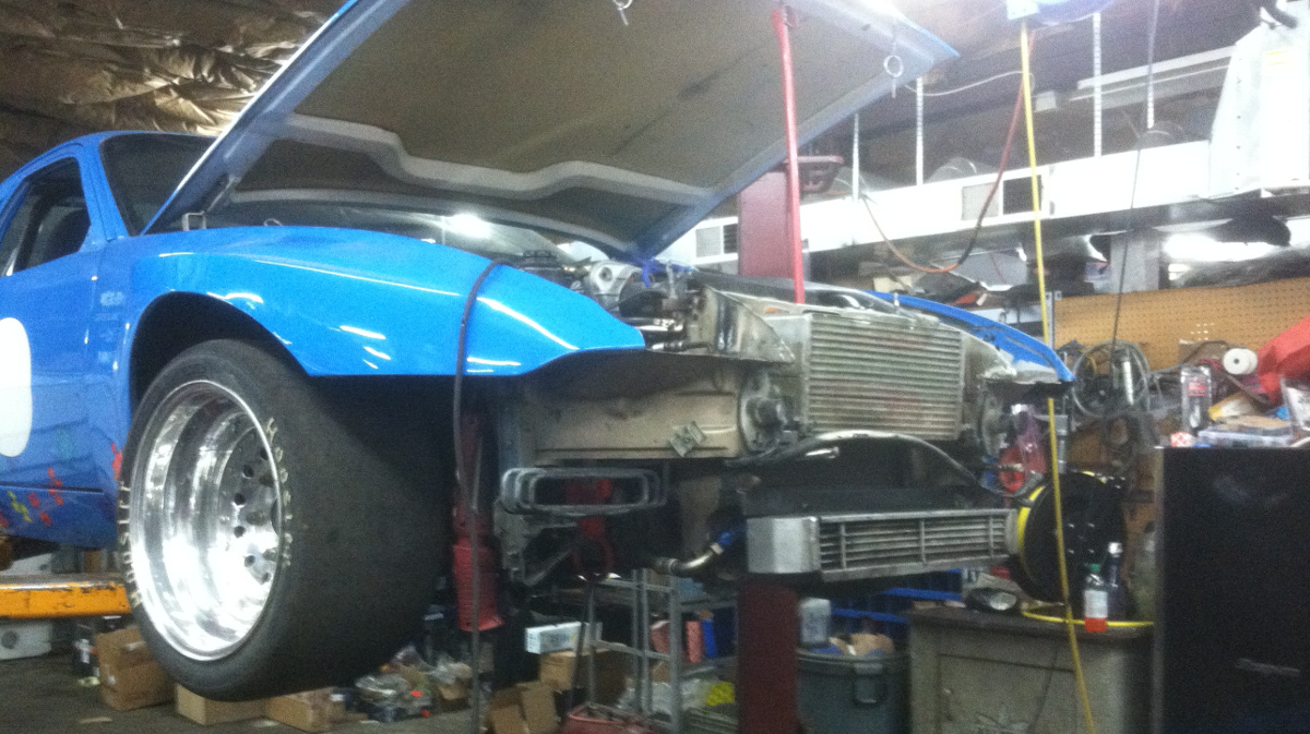 image of a high performance race car on a lift in Autobahn Centre's Shop